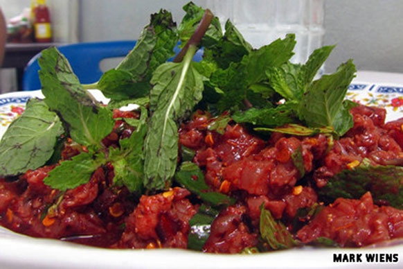 Larb Leuat Neua: Món ăn này gồm thịt bò thái mỏng, rắc thêm rau húng và rưới tiết bò tươi. Larb Leuat Neua thường được dùng như món nhậu khi uống bia.