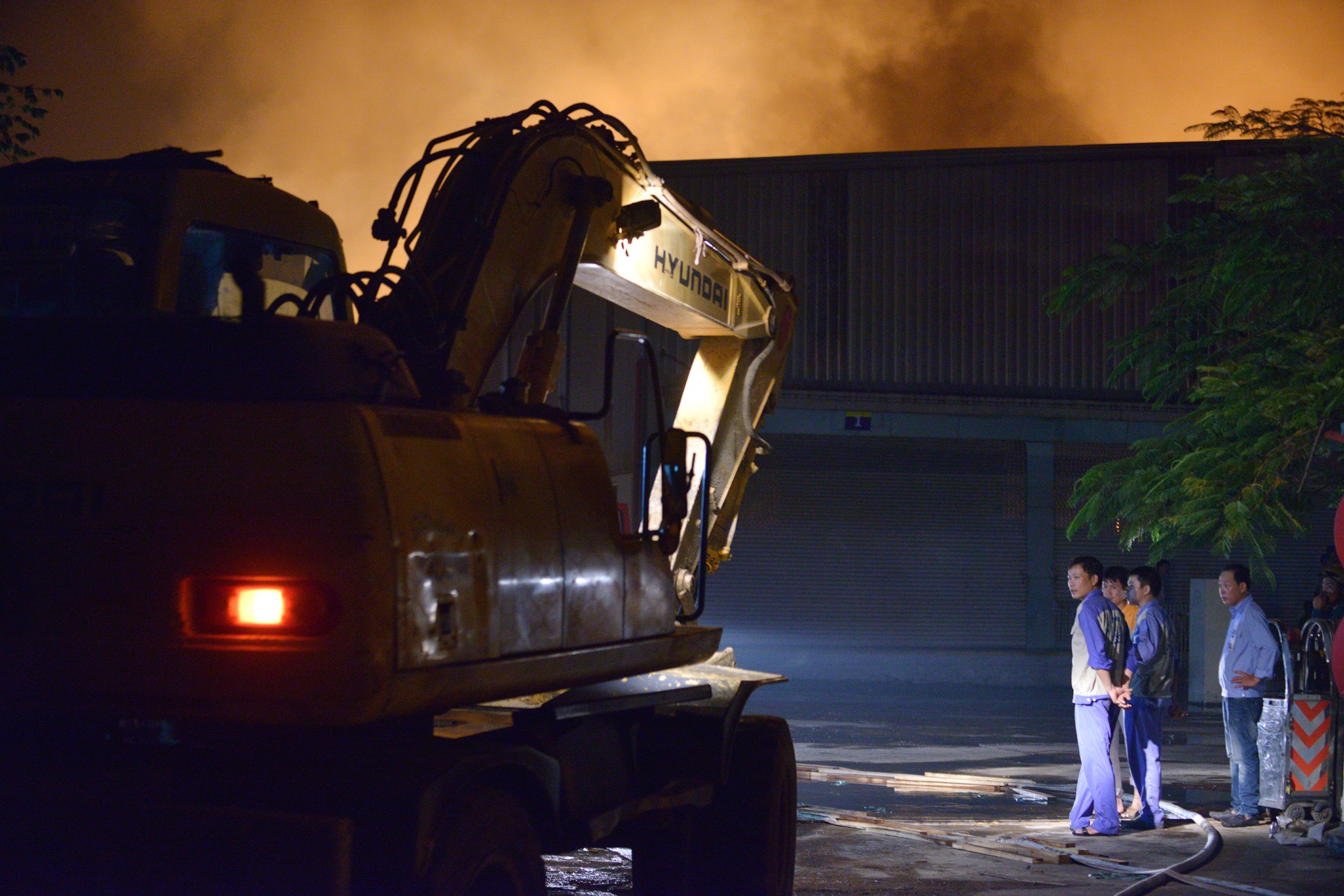 Đến 22h cùng ngày, cơ quan chức năng huy động máy ủi, máy xúc để lập lửa.
