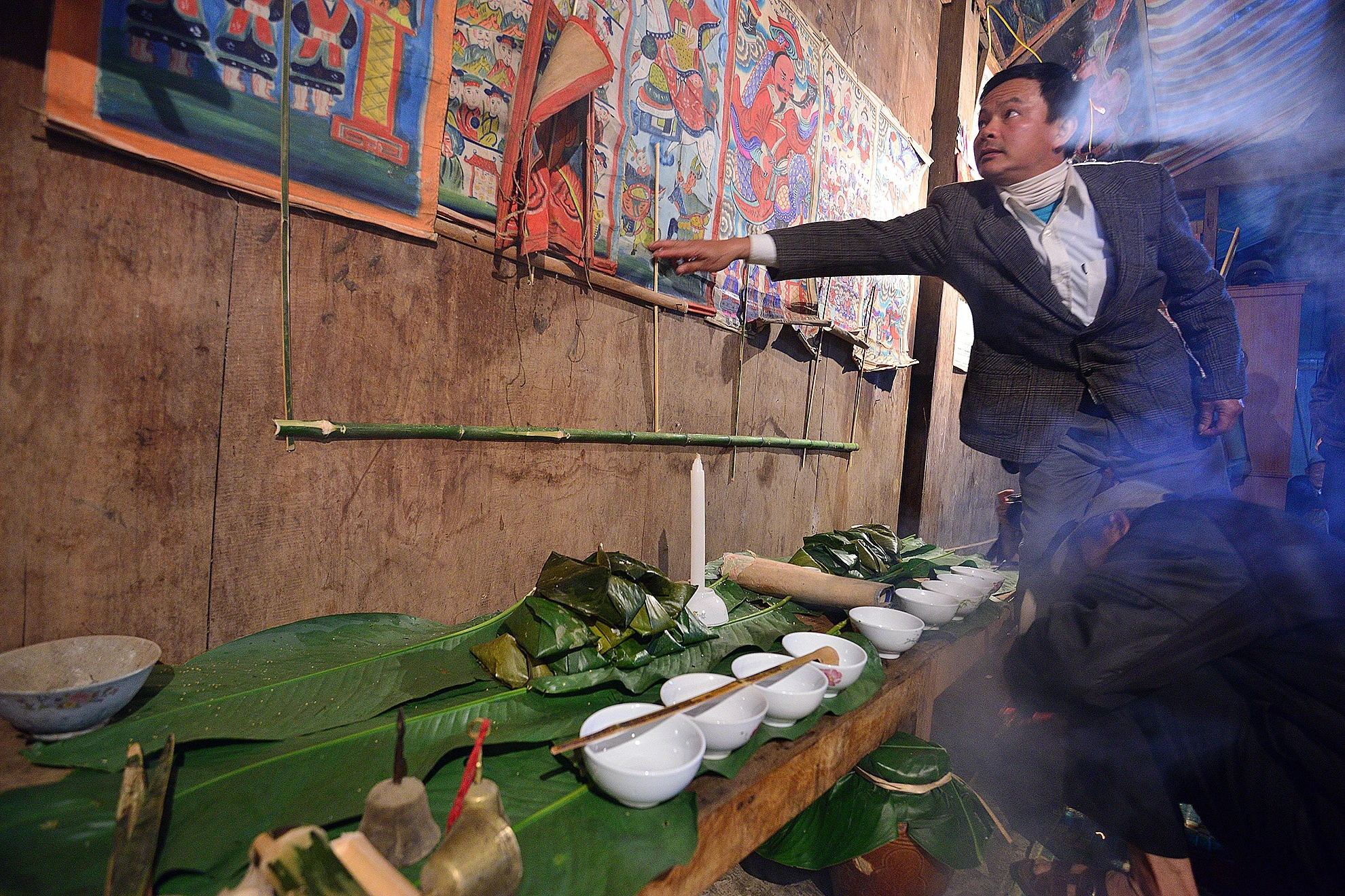 Những bức ảnh tượng trưng cho hình ảnh các thầy mo đi làm lễ, đánh trận được treo lên trước nhà.