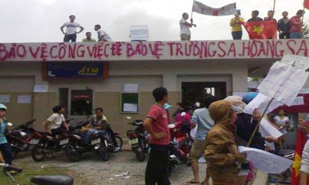 Một nhóm công nhân dùng sơn viết biểu ngữ kêu gọi bảo vệ công ăn việc làm, tránh mắc phải âm mưu kẻ xấu. Ảnh: Nguồn facebook.