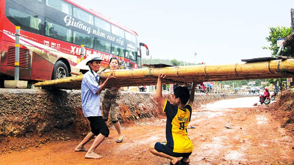 Gia đình ông Phạm Xuân Tiến (Bố Trạch, Quảng Bình) phải làm chiếc cầu tre dài hơn 4m để lấy lối đi vào nhà từ khi khởi công quốc lộ 1 cách đây cả năm trời.