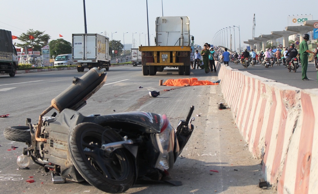 Nguoi dan ong bi xe dau keo cuon vao gam tren xa lo hinh anh