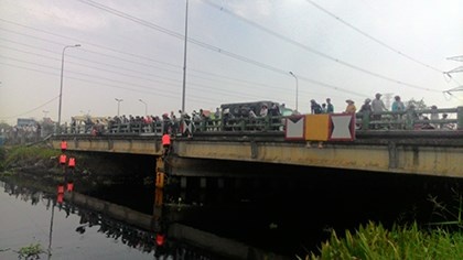 Dua vi cho xe om roi nhay xuong cau hinh anh