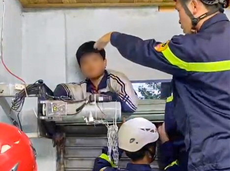 Giai cuu be trai bi ket tay vao cua cuon hinh anh