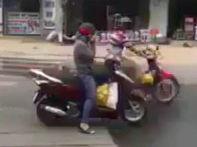 Nguoi phu nu than nhien dung giua duong nghe dien thoai hinh anh