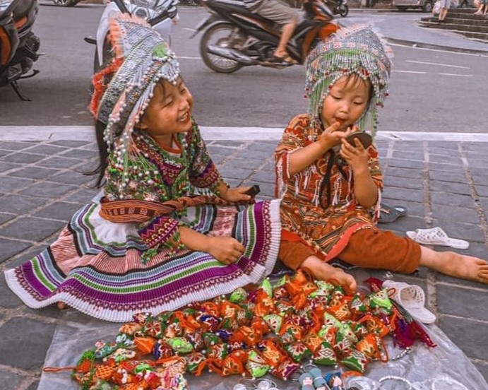 Nu cuoi gay tho cua 2 em be ban  hang rong o Sa Pa hinh anh