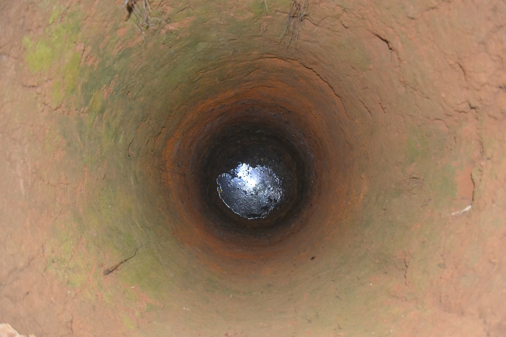 Giếng đào của người dân bỏ hoang, nước đọng đầy váng xăng dầu. Ảnh: Nguyễn Dương.