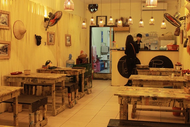 Cách bài trí quán ăn tạo cảm giác về một thời xưa cũ, với những bộ bàn ghế gỗ đơn giản, mộc mạc. Tiệm ăn tem phiếu chia làm 2 gian. Gian bên ngoài mộc mạc, giản dị với ánh sáng trắng. Gian bên trong nổi bật với đèn vàng, được trang trí hài hoà, phù hợp với thời hiện đại. 