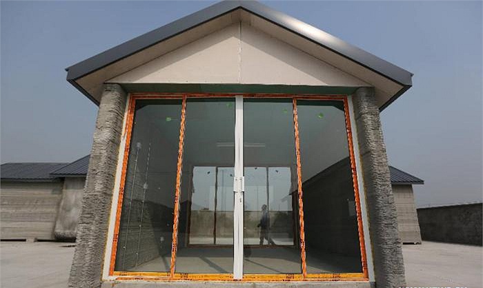 Xay 10 nha trong vong 24 gio bang may in 3D hinh anh