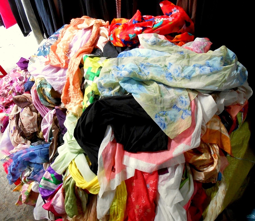 Đống khăn len, voan với đủ kiểu dáng, chất liệu được đổ đống lẫn lộn trên đường Tam Trinh, giá chỉ 15.000 - 20.000 đồng/chiếc.