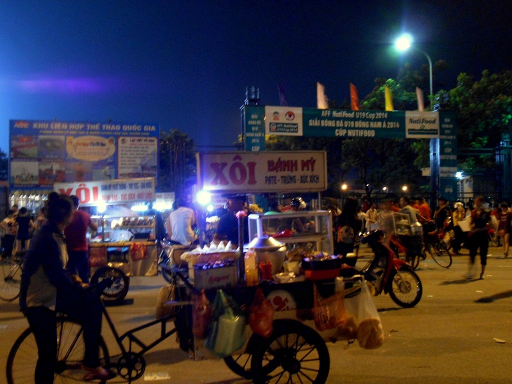 Các quán bán đồ ăn vặt di động mọc lên nhan nhản ngay cạnh cổng SVĐ.