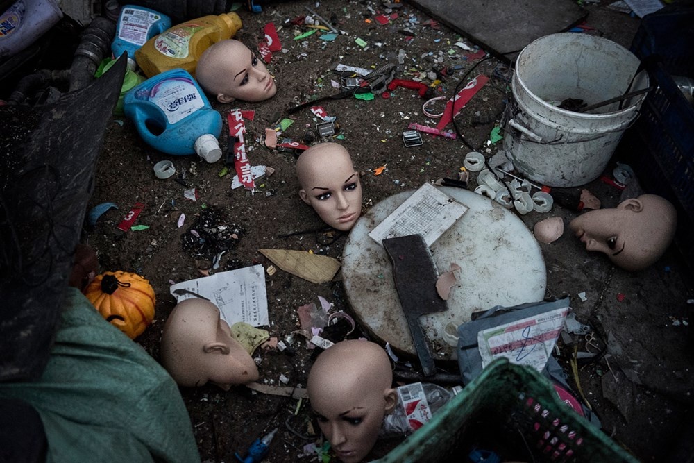 Đầu mannequin bằng nhựa và nhiều loại rác khác nằm ngay trên mặt đất. (Ảnh: Kevin Frayer/Getty Images).