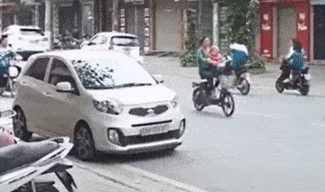 Nu tai xe mo cua oto hat vang 2 hoc sinh di xe dap dien hinh anh