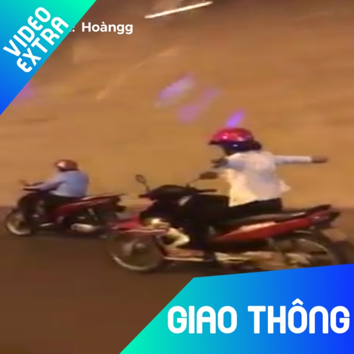 Nguoi phu nu gac chan, buong ca hai tay khi dang chay xe may hinh anh