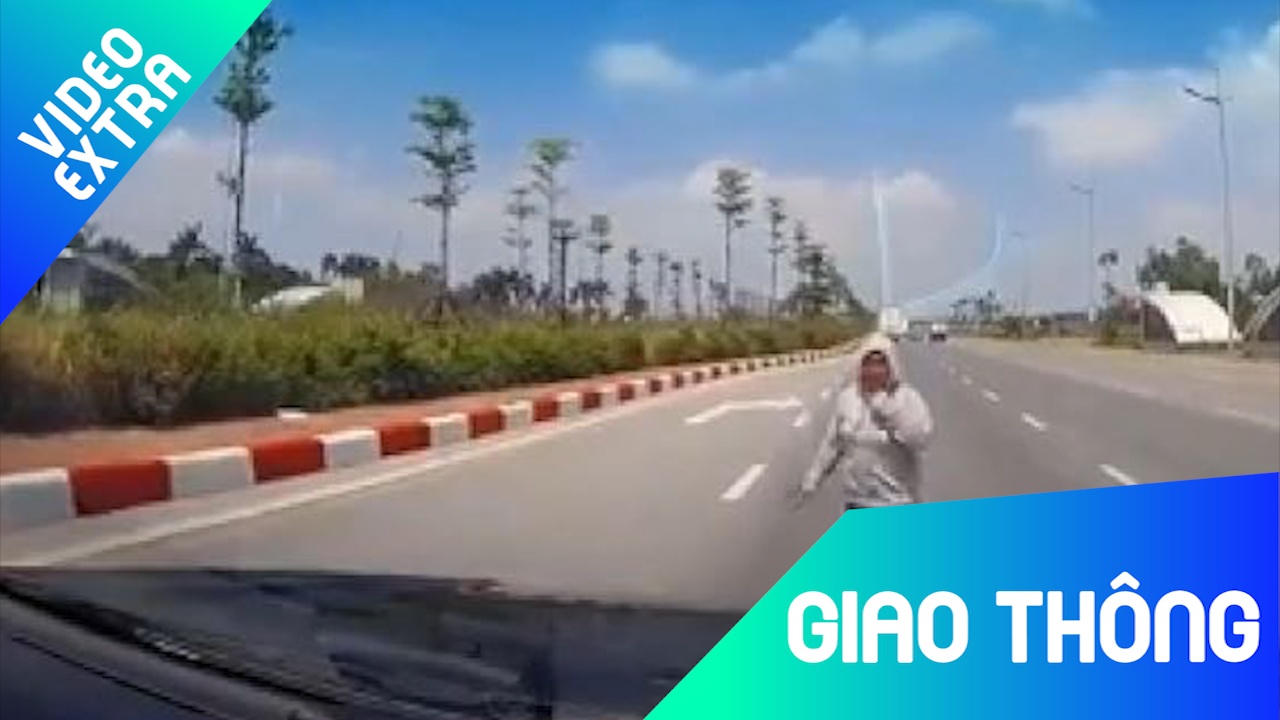 Nguoi phu nu than nhien chan dau oto de qua duong hinh anh