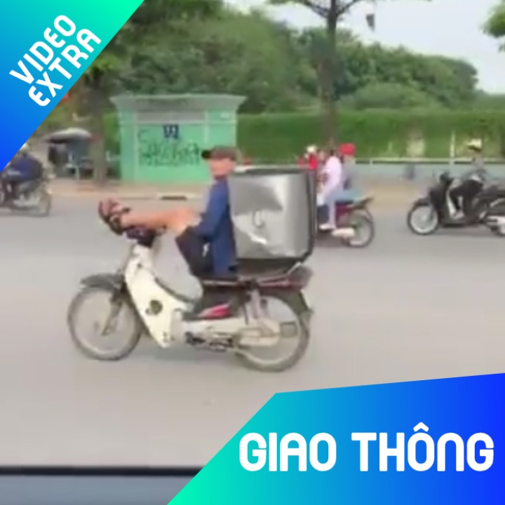 Thanh nien vua lai xe may bang hai chan, vua dung dien thoai hinh anh