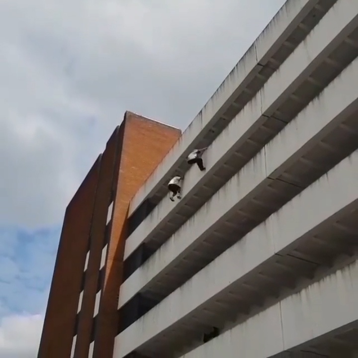 Hai chang trai dua nhau parkour tu toa nha cao tang hinh anh