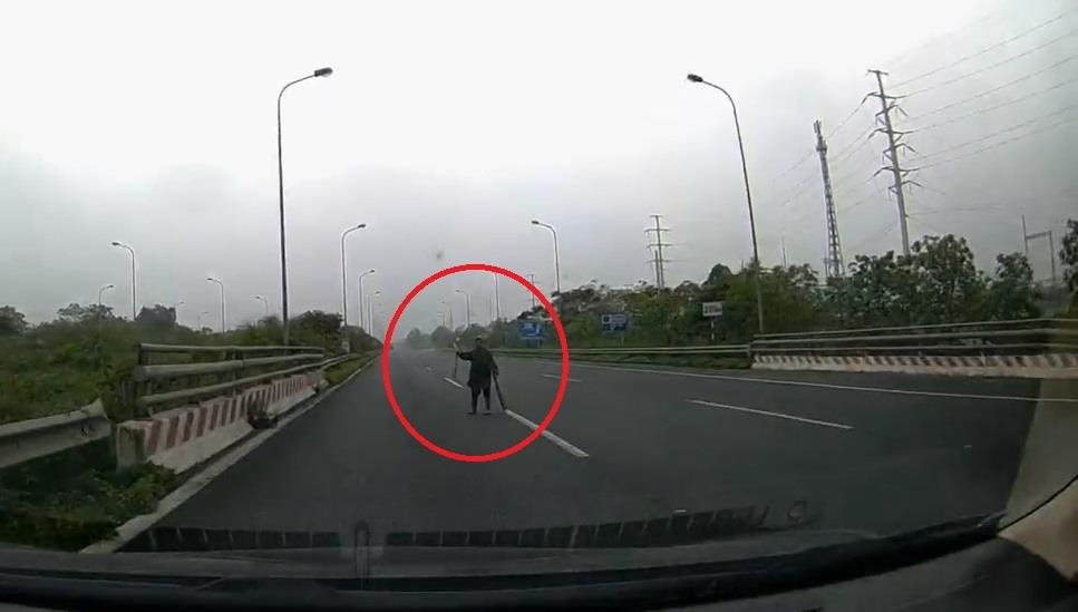 Tai xe hot hoang khi thay cu ba nhat rac giua duong cao toc hinh anh