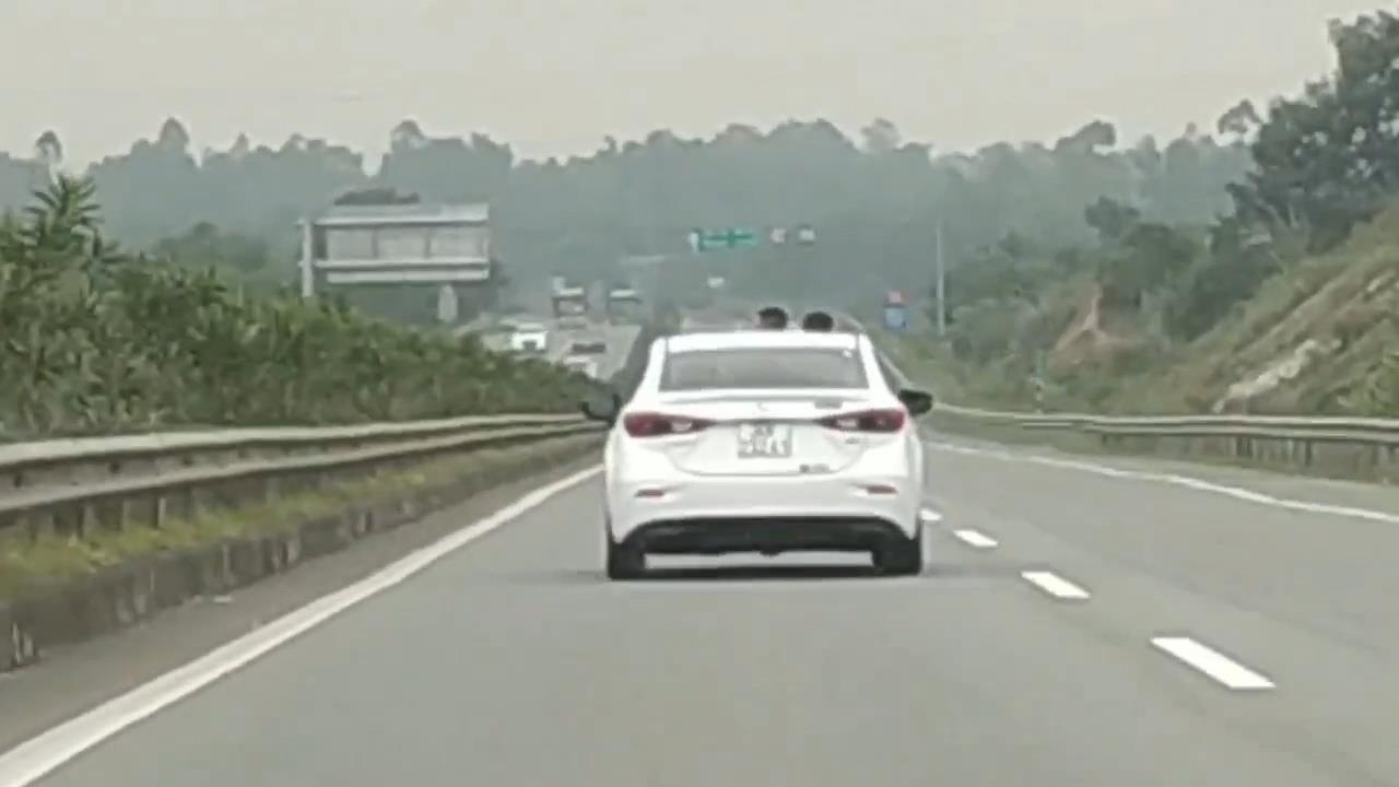 Xe chay tren 100 km/h van mo cua so troi cho hai con tho dau ra choi hinh anh