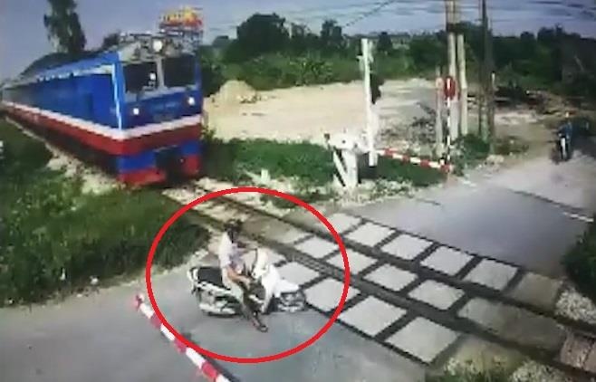 Bang qua duong sat thieu quan sat, nam thanh nien suyt bi tau can hinh anh