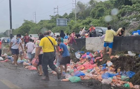 Xe lat ngua, nguoi dan do xo lay xuc xich roi xuong duong o Thai Lan hinh anh