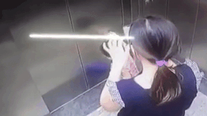 Be gai bi ket tay vao thang may trong luc me mai bam dien thoai hinh anh