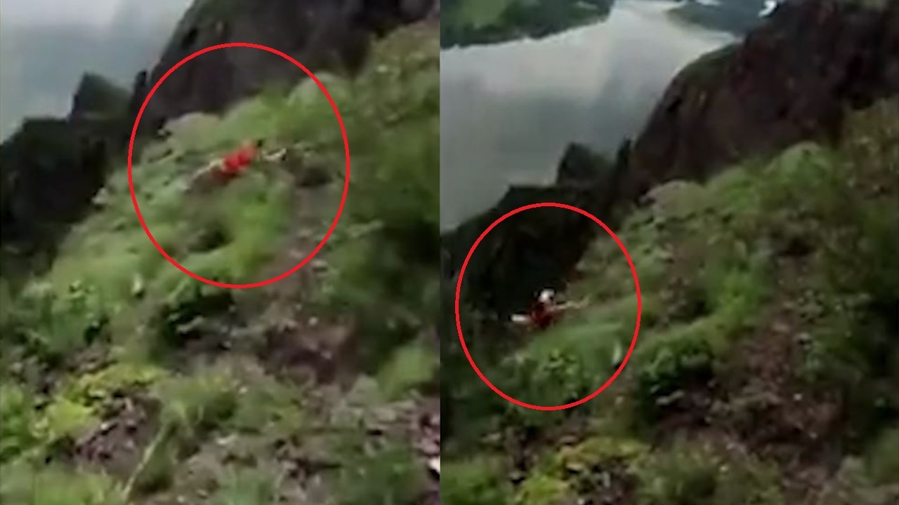 Nguoi phu nu thiet mang vi dung tren vach nui de chup anh selfie hinh anh