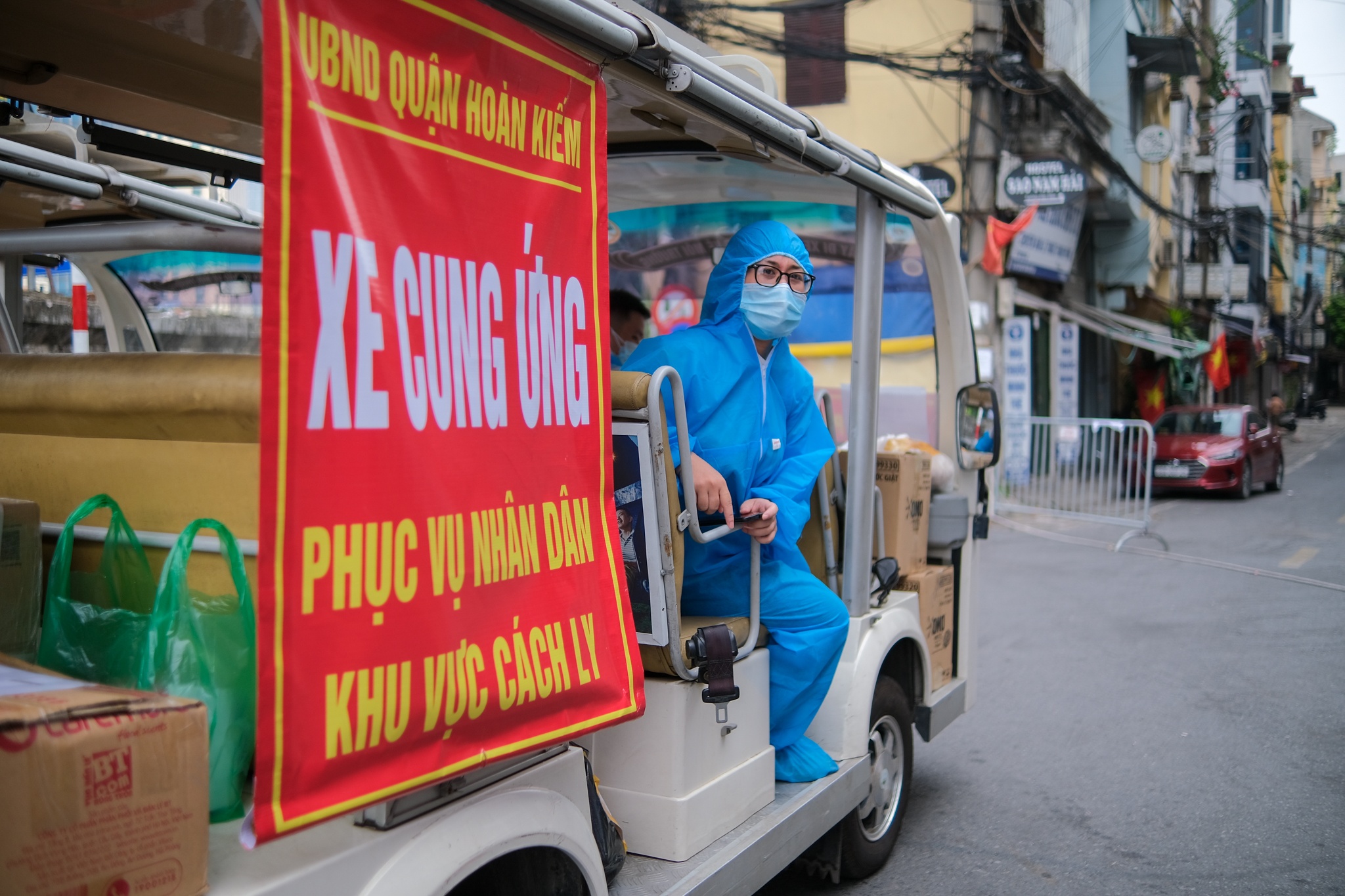 Lai xe dien tiep te do an cho nguoi dan vung phong toa o Ha Noi hinh anh