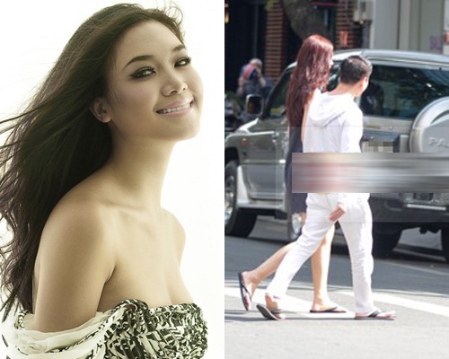 Hoa hau Thuy Dung tay trong tay voi 'trai la' giua pho hinh anh