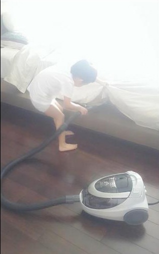 Subeo dùng máy hút bụi dọn dẹp phòng.