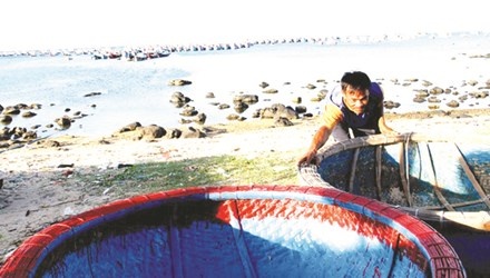 Ngư phủ Nguyễn Văn Hùng (làng chài Ghành Hang) sắp xếp những thuyền thúng chuẩn bị cho chuyến ra khơi tiếp theo. Ảnh: Đại Dương.