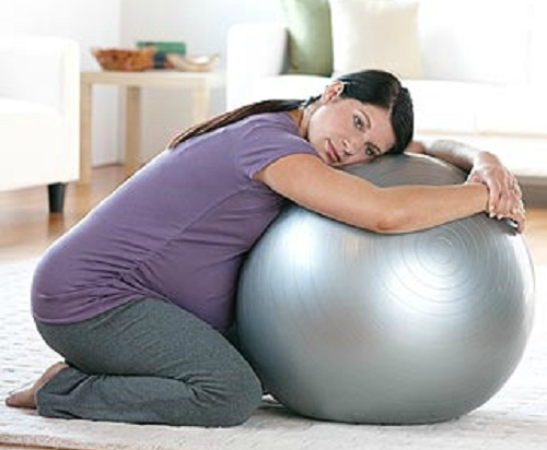 6. Quỳ gối, ôm bóng: Quỳ gối, nghiêng người về phía trước vừa giúp giảm đau, vừa làm khung xương chậu mở ra nhanh hơn. Sử dụng một quả bóng để hỗ trợ. Ở bệnh viện, mẹ bầu có thể quỳ xuống và đặt tay trên thành giường.