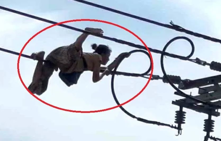 Nguoi phu nu ‘dien xiec’ bo tren day dien o TP.HCM hinh anh