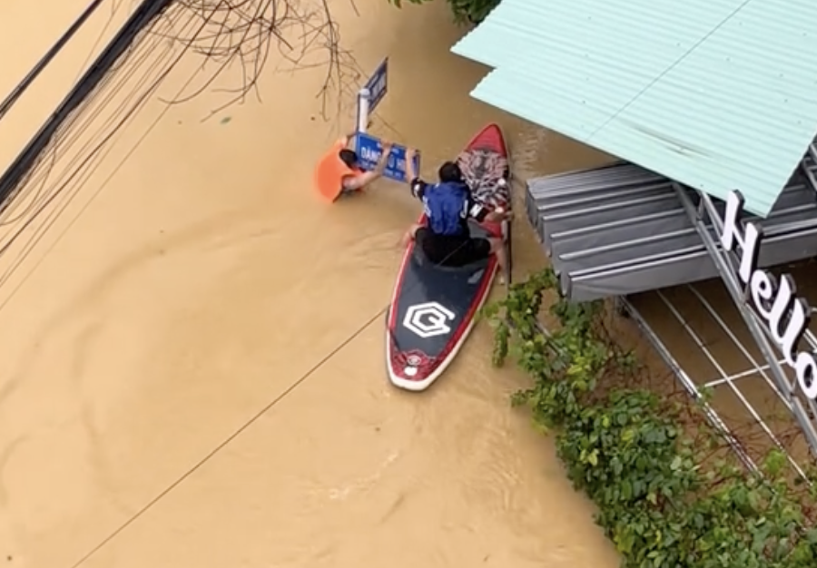 Khoanh khac nguoi dan ong lieu minh cheo sup cuu nguoi giua lu hinh anh