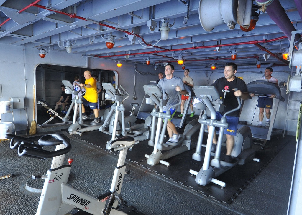 Một số thủy thủy bắt đầu buổi sáng bằng bài tập nhẹ nhàng trong phòng tập trên tàu.