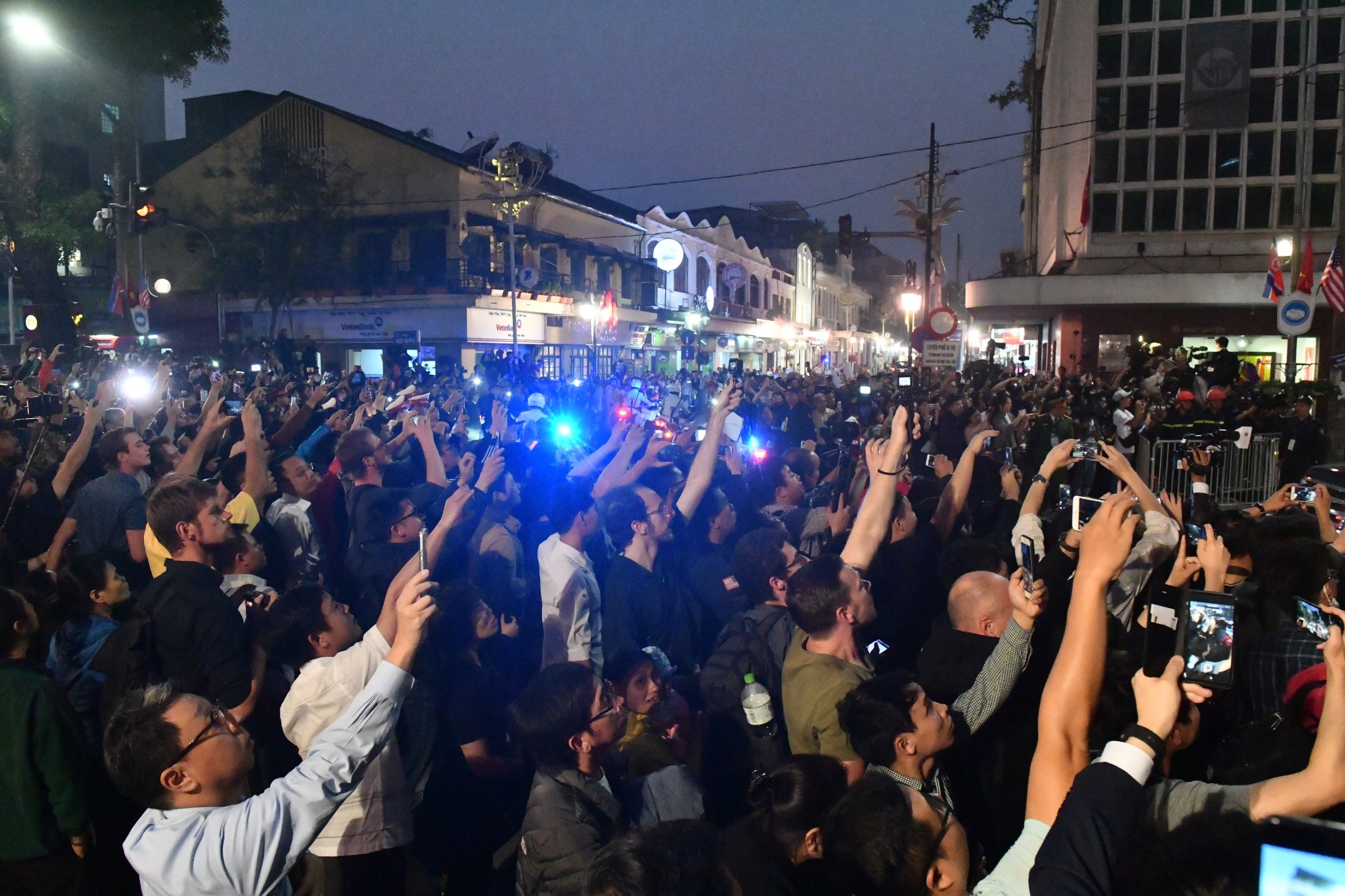 Nguoi dan tran xuong duong don doan xe ong Trump, ong Kim hinh anh