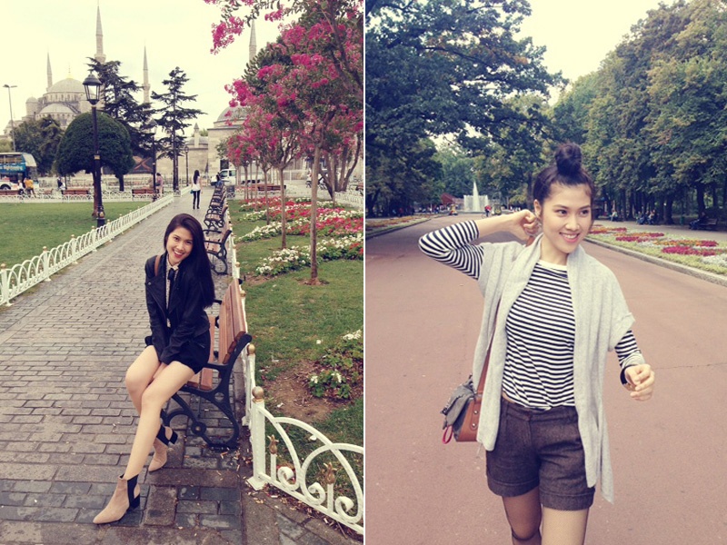 Thu Hằng ngắm cảnh và tạo dáng bên những khóm hoa trên đường phố.