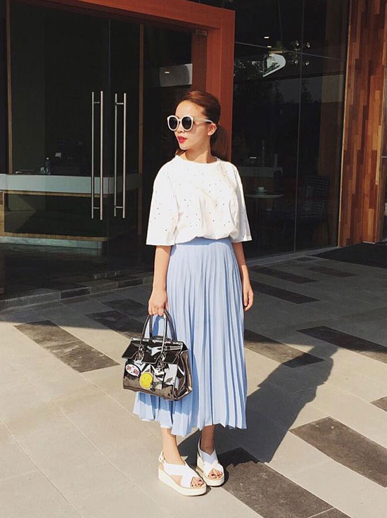 Yến Trang duyên dáng hơn khi diện váy xếp ly voan màu xanh pastel  mix cùng áo sơ mi trắng, túi xách ánh bạc.