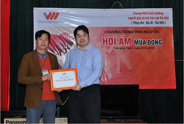 Đại diện Công ty viễn thông Vietnamobile trao quà cho Trung tâm nuôi dưỡng người già và trẻ em tàn tật Hà Nội.