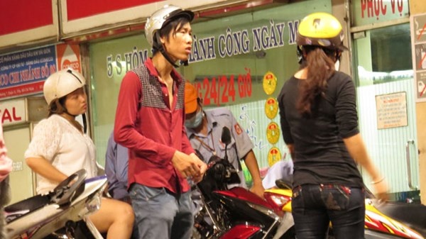 Nam thanh niên đang xin tiền người đổ xăng.