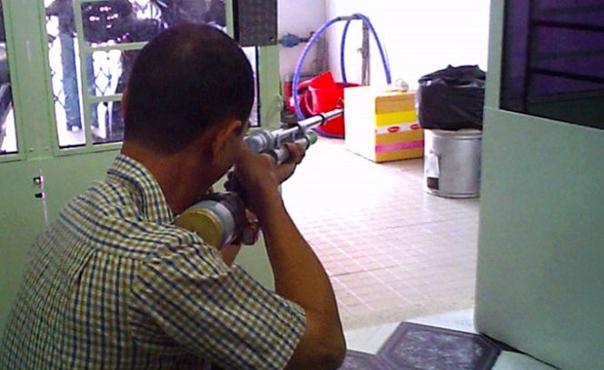Ông Châu bắn thử súng cồn tự chế.