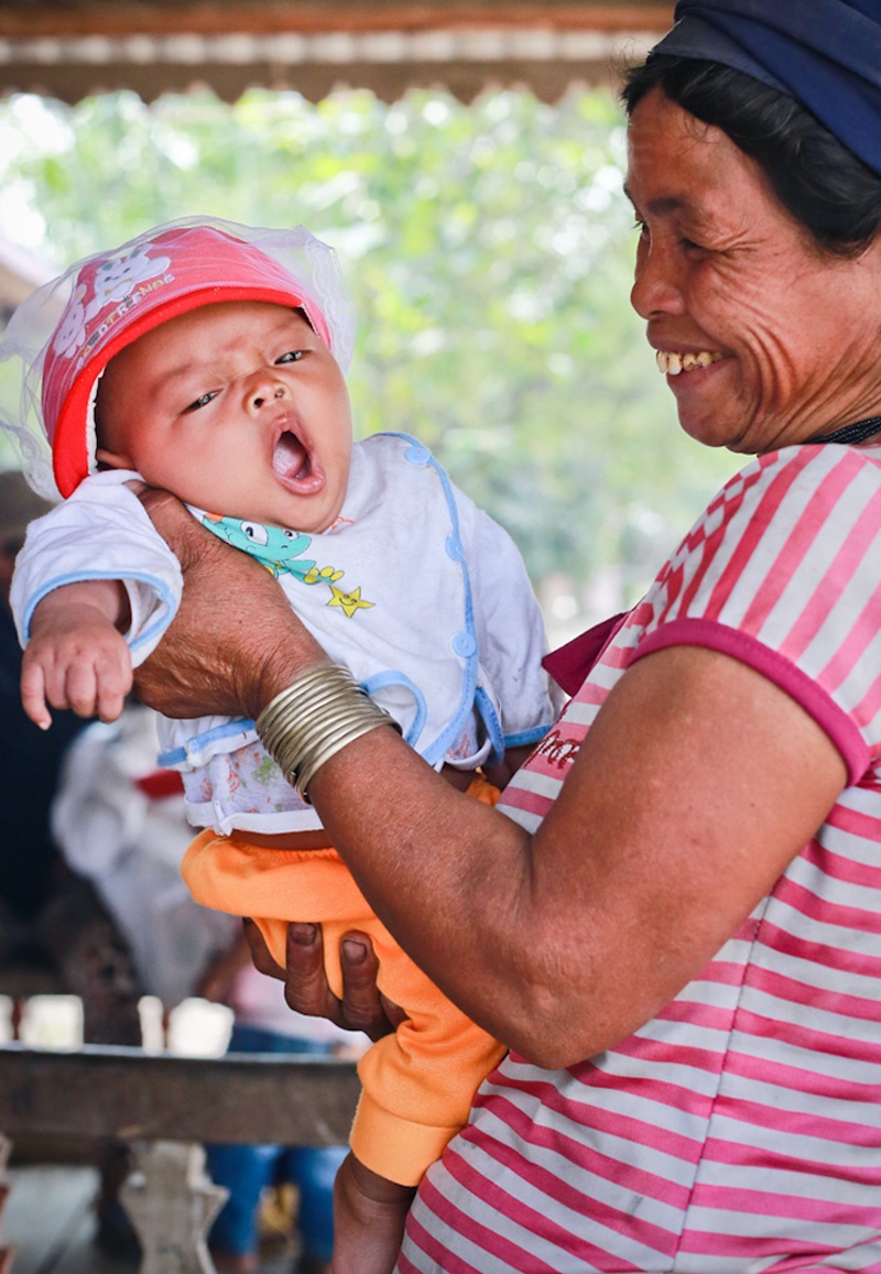 Bà Đinh Thị Bơn (65 tuổi) là một trong những thành viên cao tuổi nhất trong đội chiêng nữ nựng cháu gái 5 tháng tuổi.