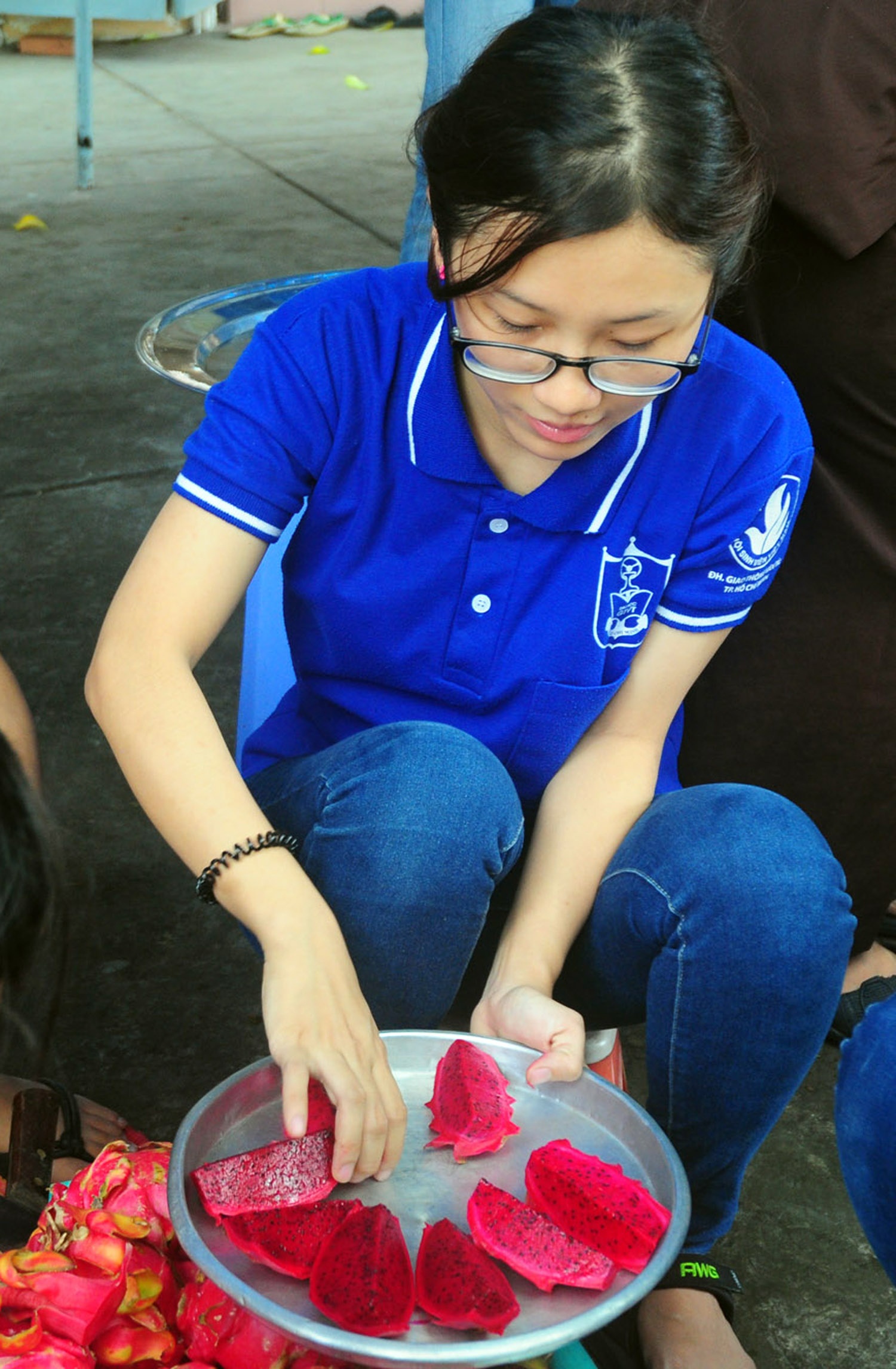 Sau mỗi bữa cơm, các sỹ tử lại được ăn trái cây tráng miệng do các bạn sinh viên tình nguyện tự tay làm. ảnh 20: Trâm, sinh viên trường ĐH GTVT cẩn thận trang trí dĩa thanh long thật bắt mắt dành cho thí sinh.