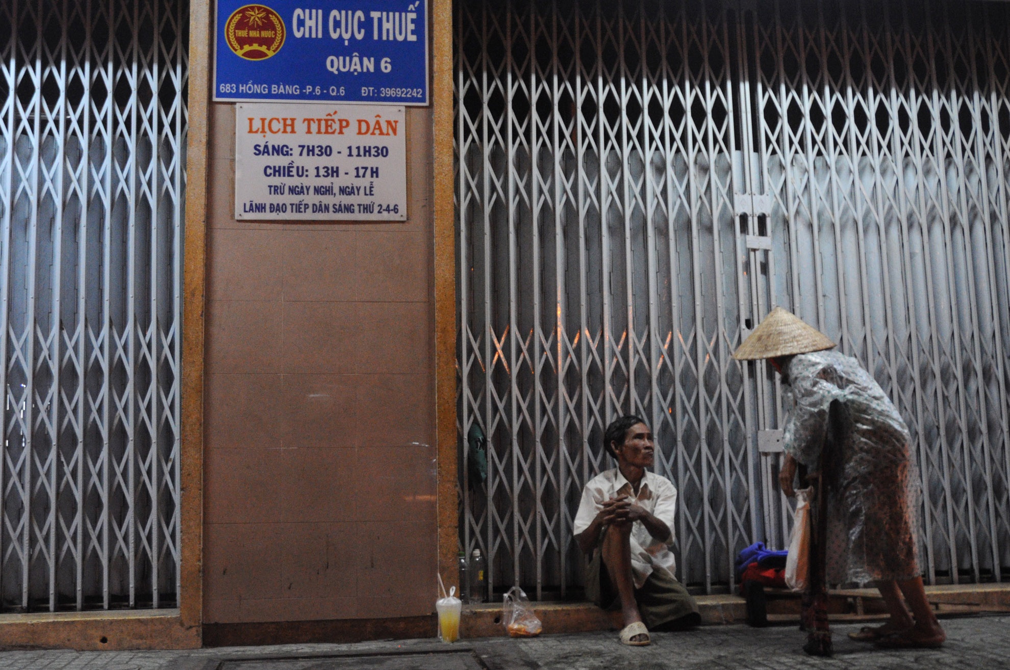 Những người cùng cảnh ngộ. Hai ông bà bán vé số dạo đang trú mưa tại đường Hồng Bàng (quận 6).
