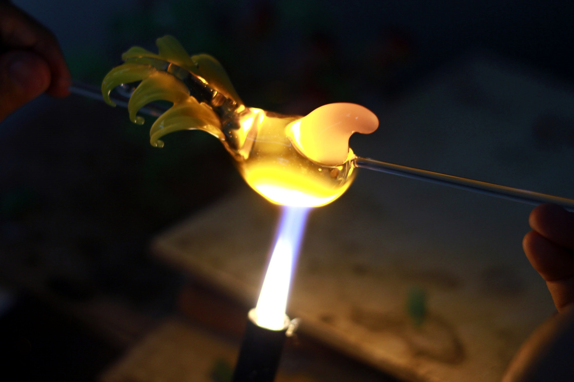 Dưới ngọn lửc nhiệt độ cao bàn tay anh cực kỳ khéo léo di chuyển, lúc xoay tròn liên tục, lúc chậm rãi khoan thai, lúc dứt khoát những đường kéo mạnh. Thanh thủy tinh dài bỗng biến hình một cách kỳ diệu.