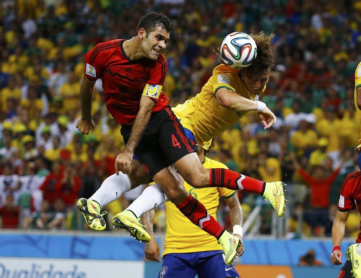 david-luiz-of-brazil-heads-the-ball-away-from-mexicos-rafael-marquez