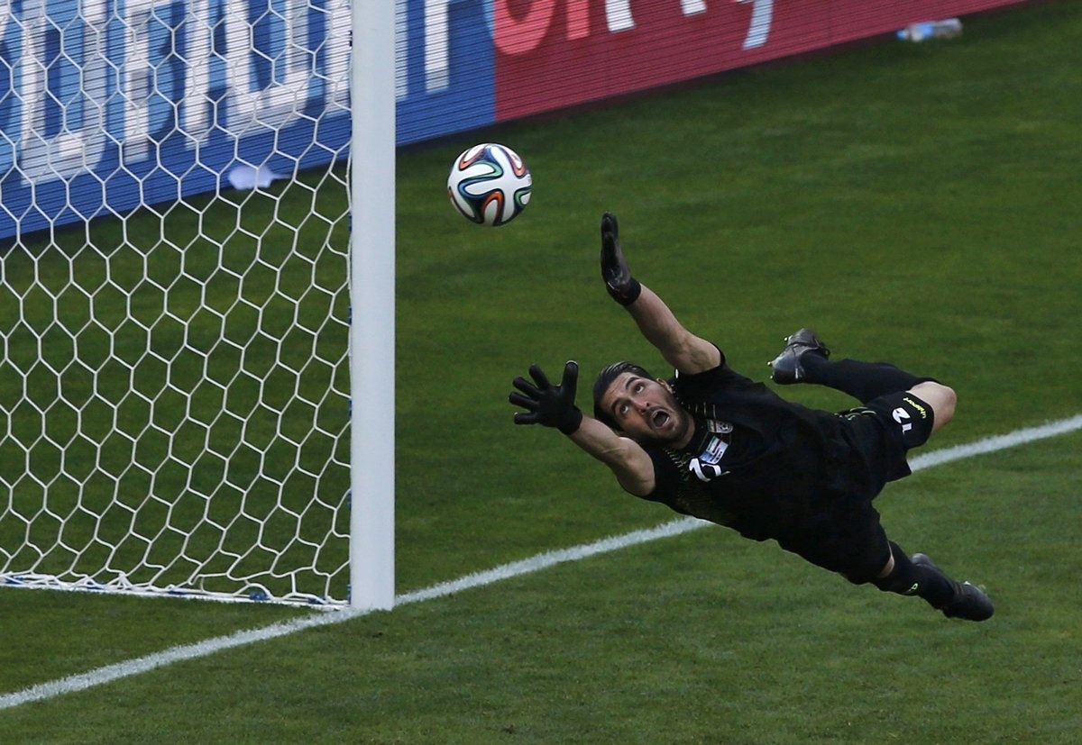 irans-goalie-alireza-haghighi-tries-and-fail-to-save-a-messi-goal.