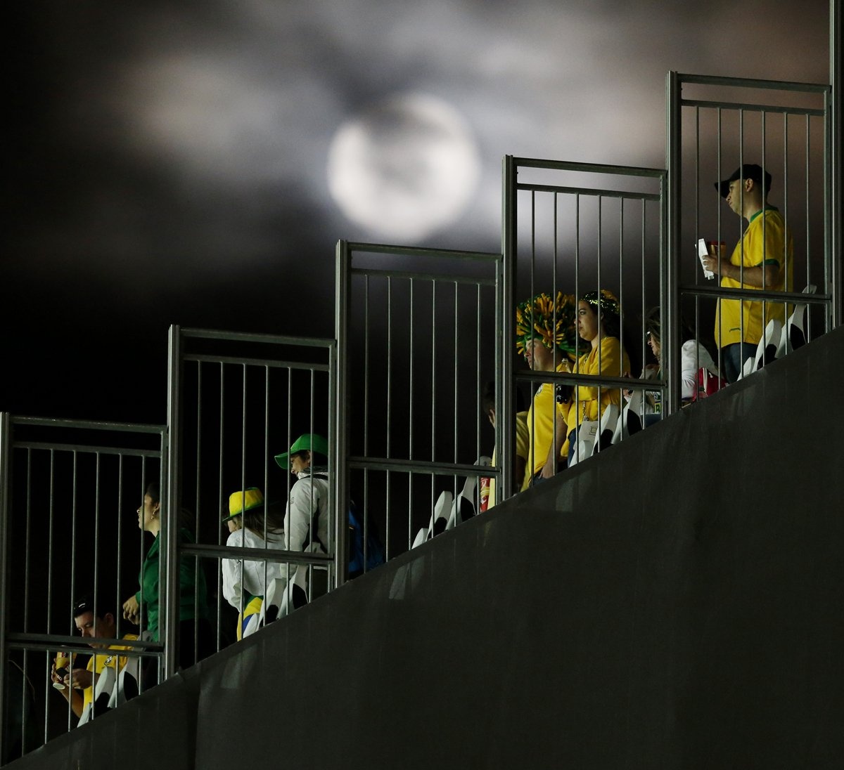 the-moon-shines-bright-as-fans-get-ready-to-leave-the-stadium-after-the-opening-game.