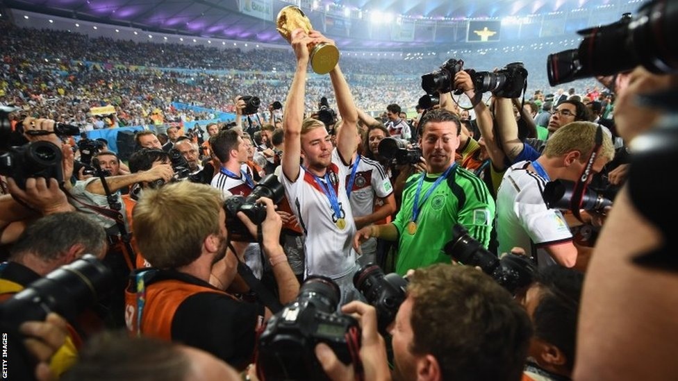 An emotional Christoph Kramer of Germany, who made his full World Cup debut in the final and came off injured, holds aloft the World Cup