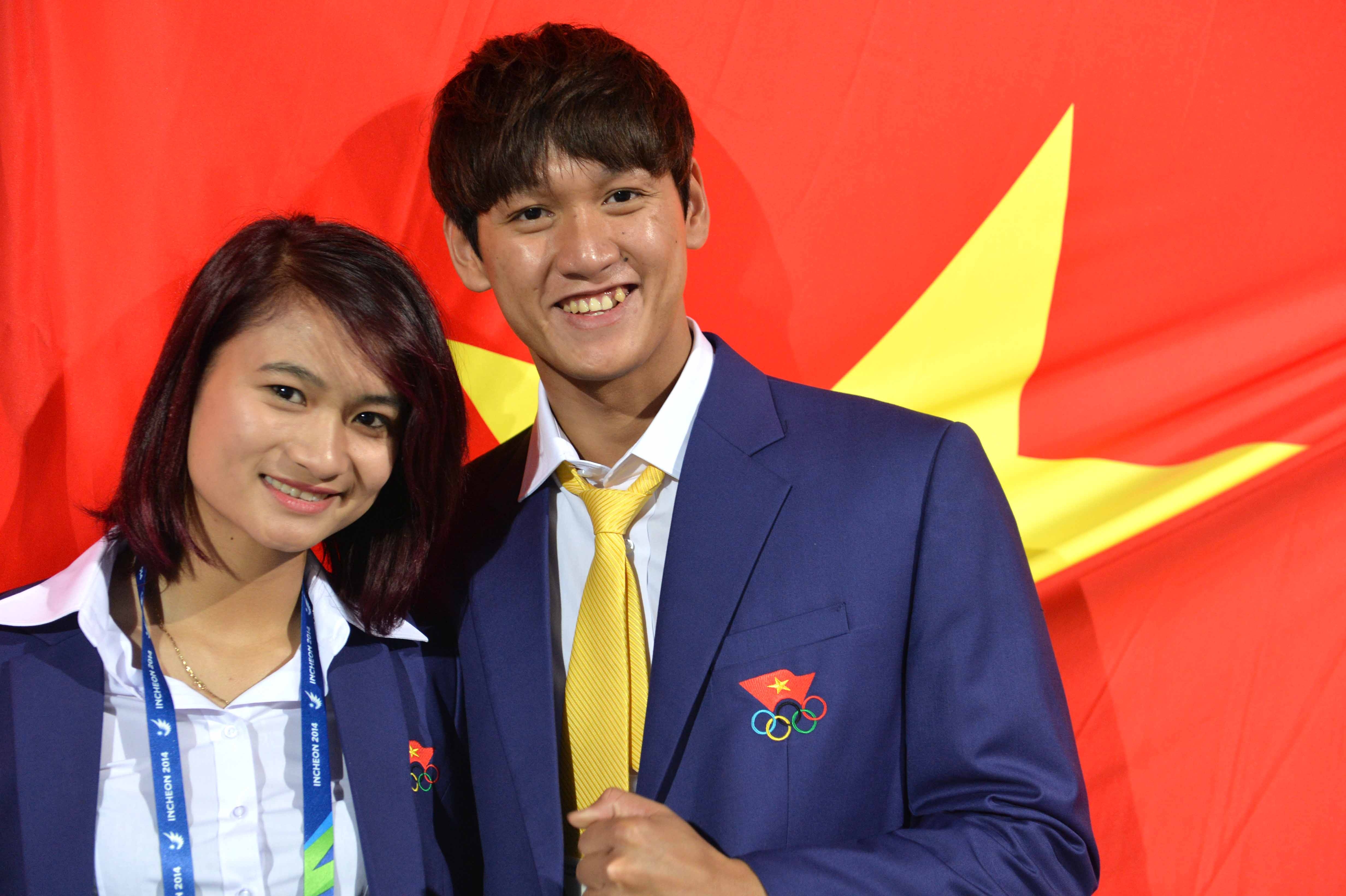 Người cầm cờ Hoàng Quý Phước (phải) chụp hình cùng niềm hy vọng ở môn điền kinh Nguyễn Thị Oanh.